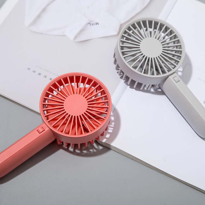 	Portable handheld fan showing USB charging port