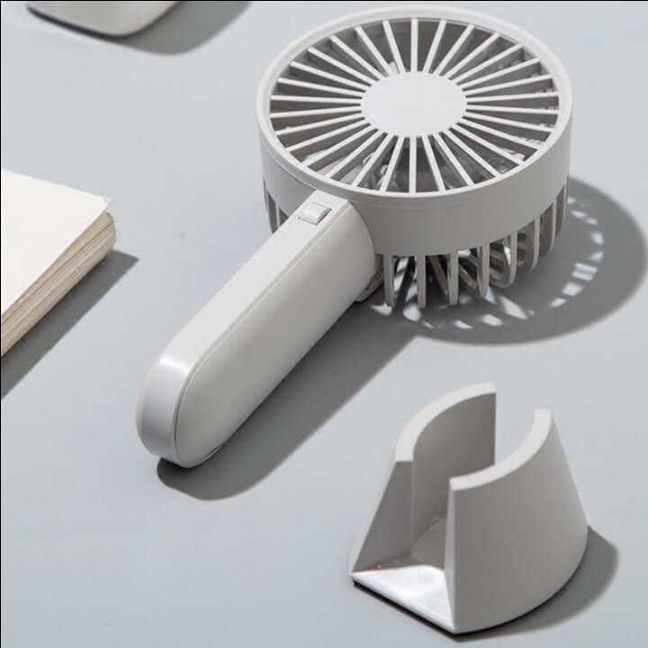 	Portable handheld fan in use outdoors
